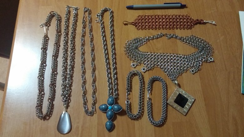 chainmaille elry. Several different pieces of chainmaille that I've made, each is a different style of weave or a mix of two weaves, the pen in pic is for scale