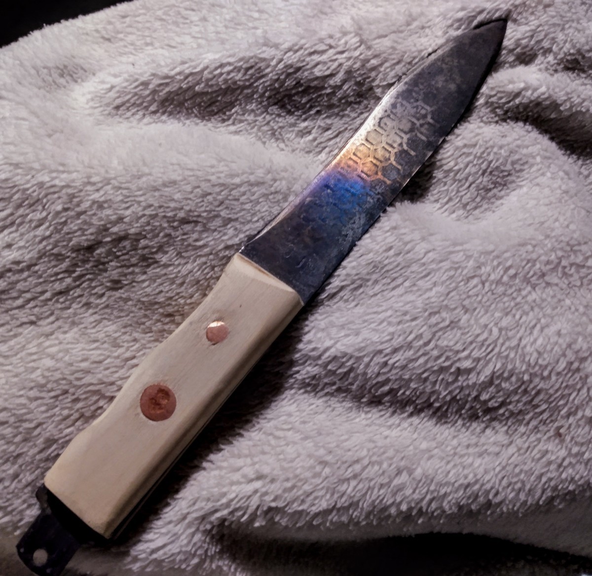 Kive. Carven of a sawsall blade and with a handle of poplar riveted with copper nails and featuring temper colors on the blade which likely over the metallurgy.
