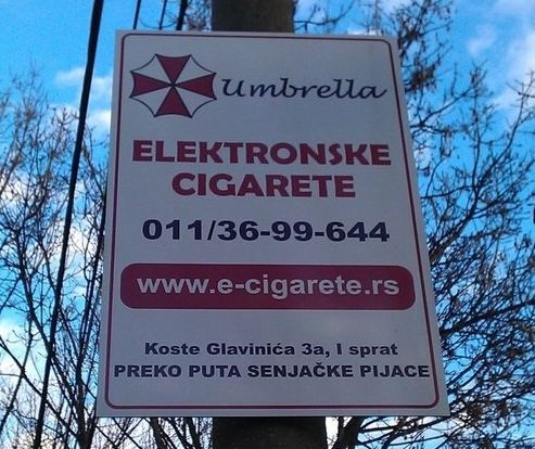 They are real. I saw bilbord like this in Belgrade. I went to internet to check it and yep they are real. Umbrella corporation dealing in electric cigars link t