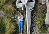 Human next to whale skull