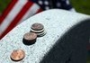 What the coins left on a headstone mean