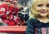 Hockey players are pretty chill smiling with this adorable girl